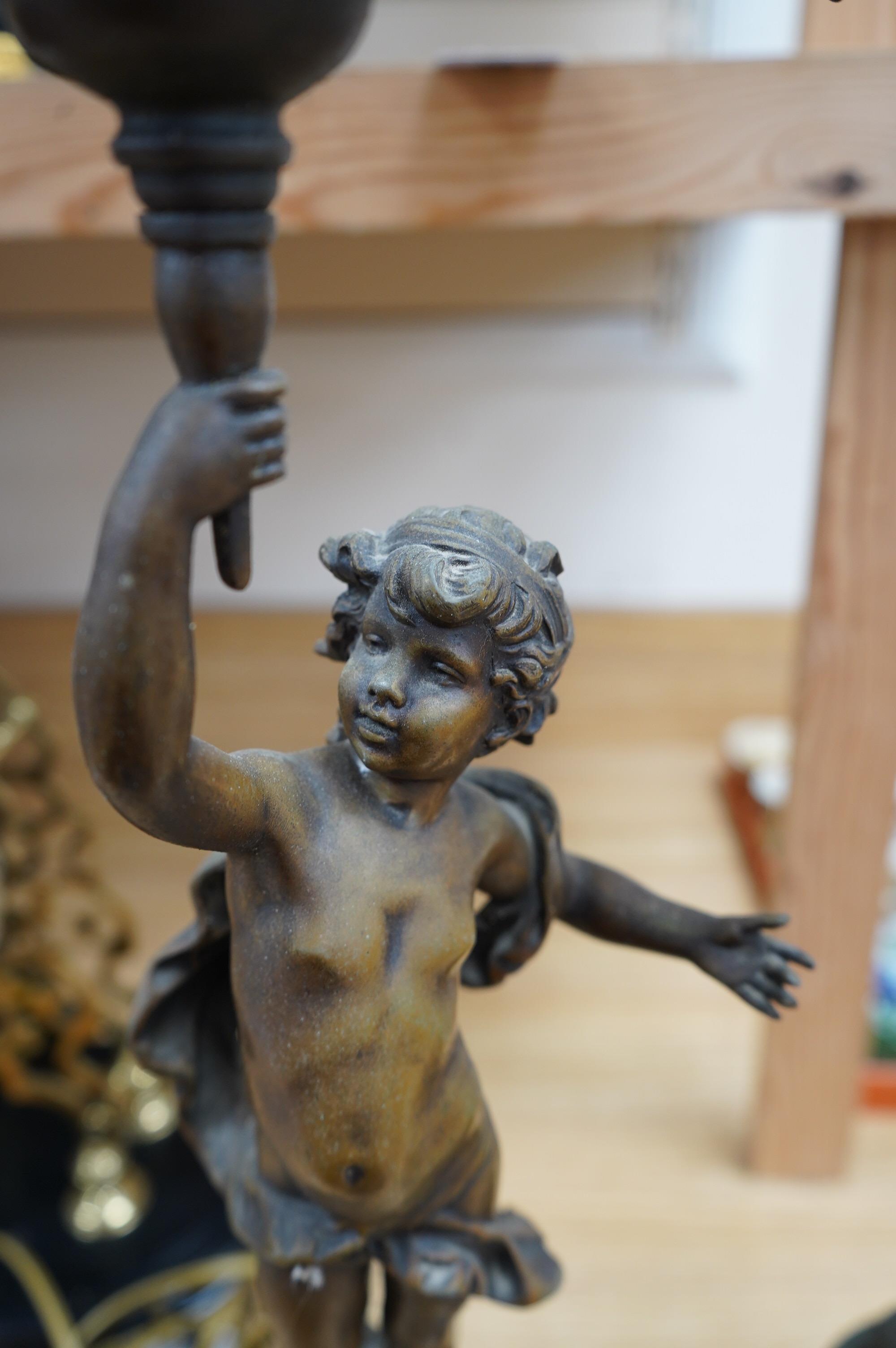 A pair of bronzed spelter ‘putto’ lamps, serpentine marble bases, 60cm. Condition - fair to good, not tested